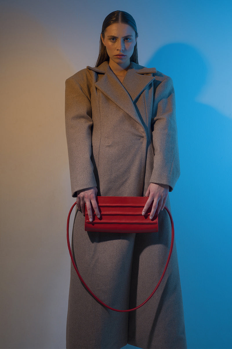 Long beige full-length coat with padded shoulders