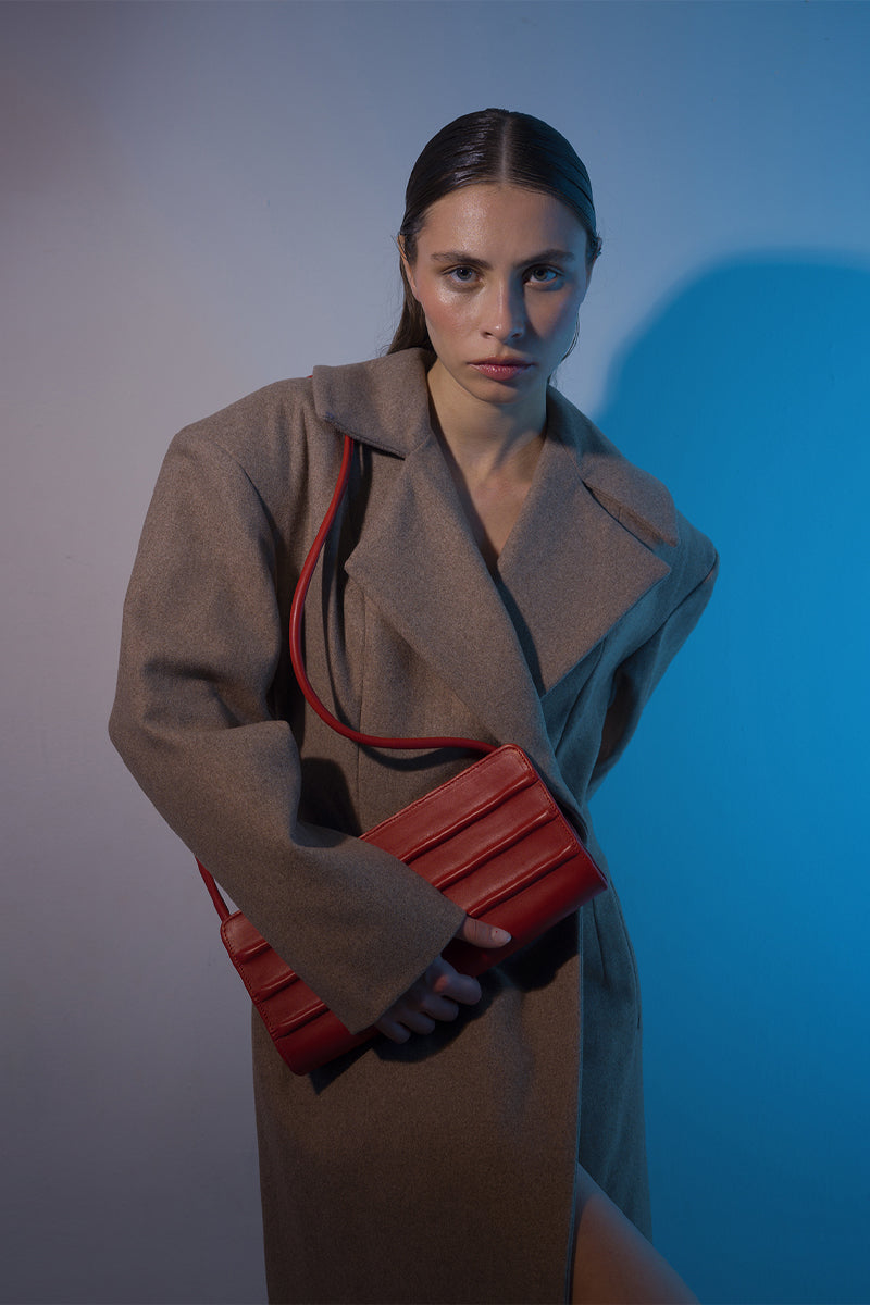 Long beige full-length coat with padded shoulders