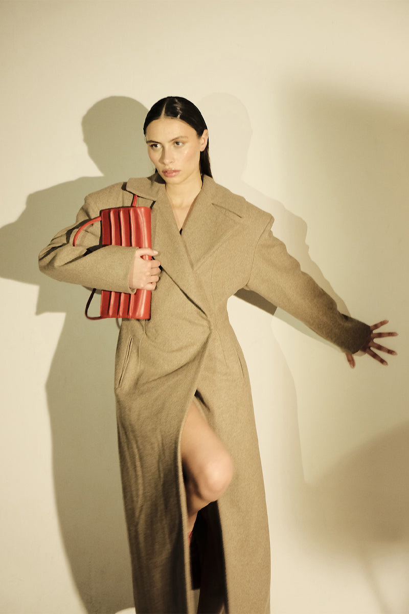 Long beige full-length coat with padded shoulders